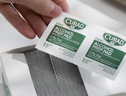 hand holding alcohol pads