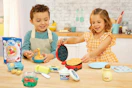 lifestyle image of children playing with a little tikes waffle playset