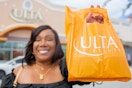a woman holding an ulta bag outside of an ulta 