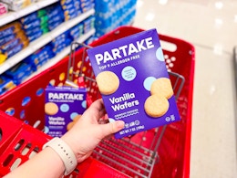 hand holding a box of partake vanilla wafers over a target cart