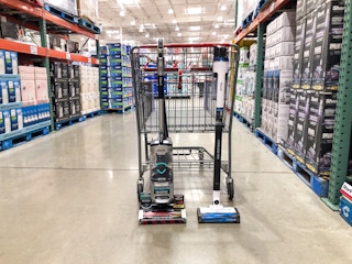 2 shark vacuums in front of a cart