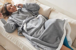 woman on couch wearing a Bedsure Wearable Blanket Hoodie