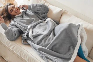 woman on couch wearing a Bedsure Wearable Blanket Hoodie