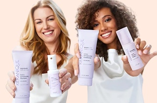 two women holding Keranique products