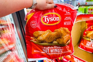 hand holding a bag of tyson chicken wings