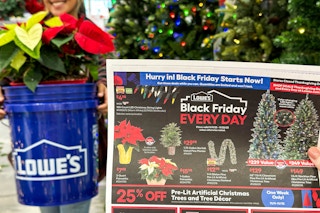 a lowes bucket with poinsettias inside being held next to a black friday ad  