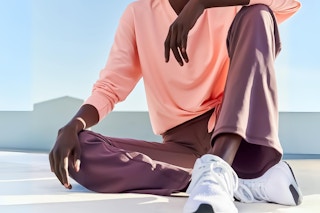 Lifestlye image of Women wearing a pair of Avia Flare Leggings sitting down outside