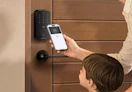 a family unlock their front door with their phone
