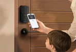 a family unlock their front door with their phone