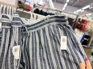 linen pants on hangers in store at old navy