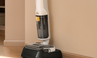 a wet dry vacuum mop against a wall