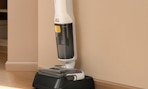 a wet dry vacuum mop against a wall
