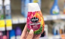 hand holding Renuzit Air Freshener cone in aisle