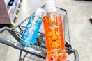 person holding a bottle of safeguard hand soap over a cart with another bottle of soap in it
