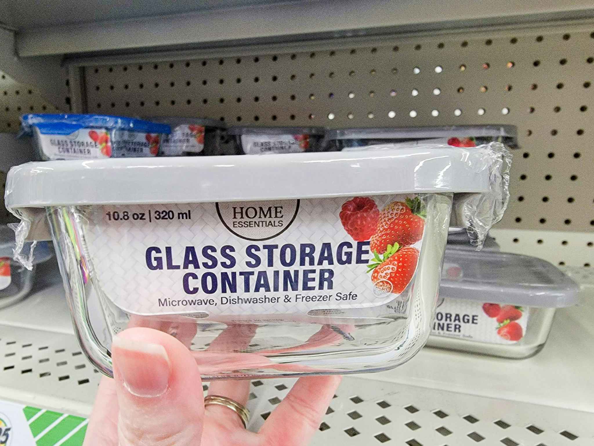 hand holding a glass food storage container