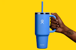 a woman holding a hydro flask tumbler