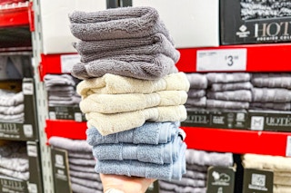 person holding a stack of washcloths
