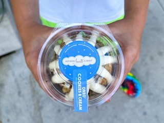 A boy holding an Oreo cookies and cream cake from Nothing Bundt Cakes