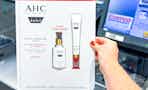 hand holding a pack of ahc skincare