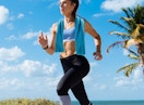 a woman running with a cooling towel outside