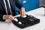 man using electronic case organizer at desk