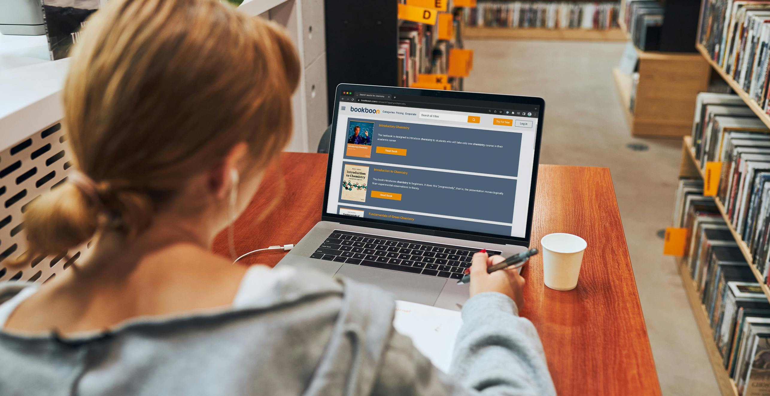  A woman is using a laptop to search for information about educational apps for college textbooks.