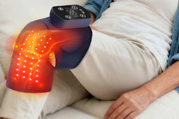 a woman wearing a heated knee massager