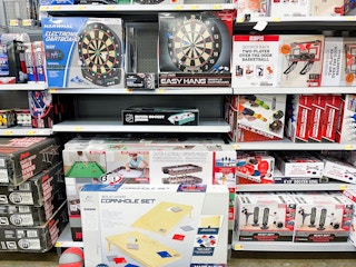 A variety of games sitting on the store shelf.