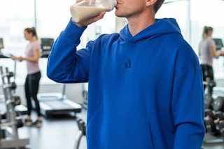 a man drinking a protein shake