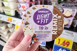 hand holding a cup of dannon remix yogurt