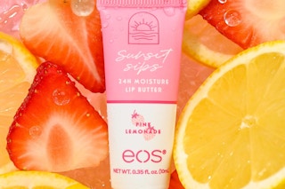a lip balm tube on top of strawberries and lemons