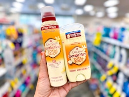 hand holding two old spice total body deodorants