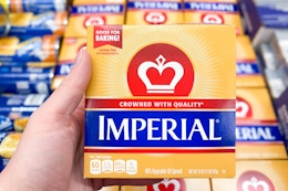 hand holding a pack of imperial butter
