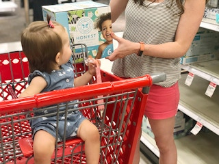 woman and baby shopping in target for diapers
