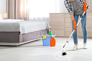 Lifestyle image of person cleaning with an electric spin brush (used it to clean floors)