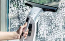 a cordless window cleaner cleaning a window