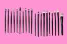 makeup brushes on a pink background