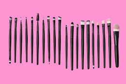 makeup brushes on a pink background