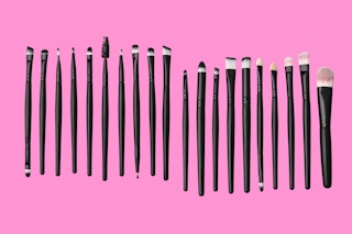 makeup brushes on a pink background