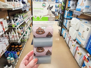 hand holding a pack of dog waste bags