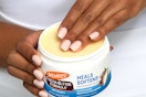 A woman's hands hold a jar of Palmer's Cocoa Butter