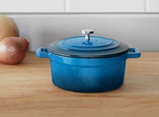 enameled blue cast iron pot on a wooden table