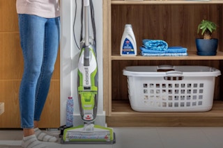 Woman standing next to the Bissell Crosswave Turbo Vacuum Mop All in One Wet and Dry Vac.