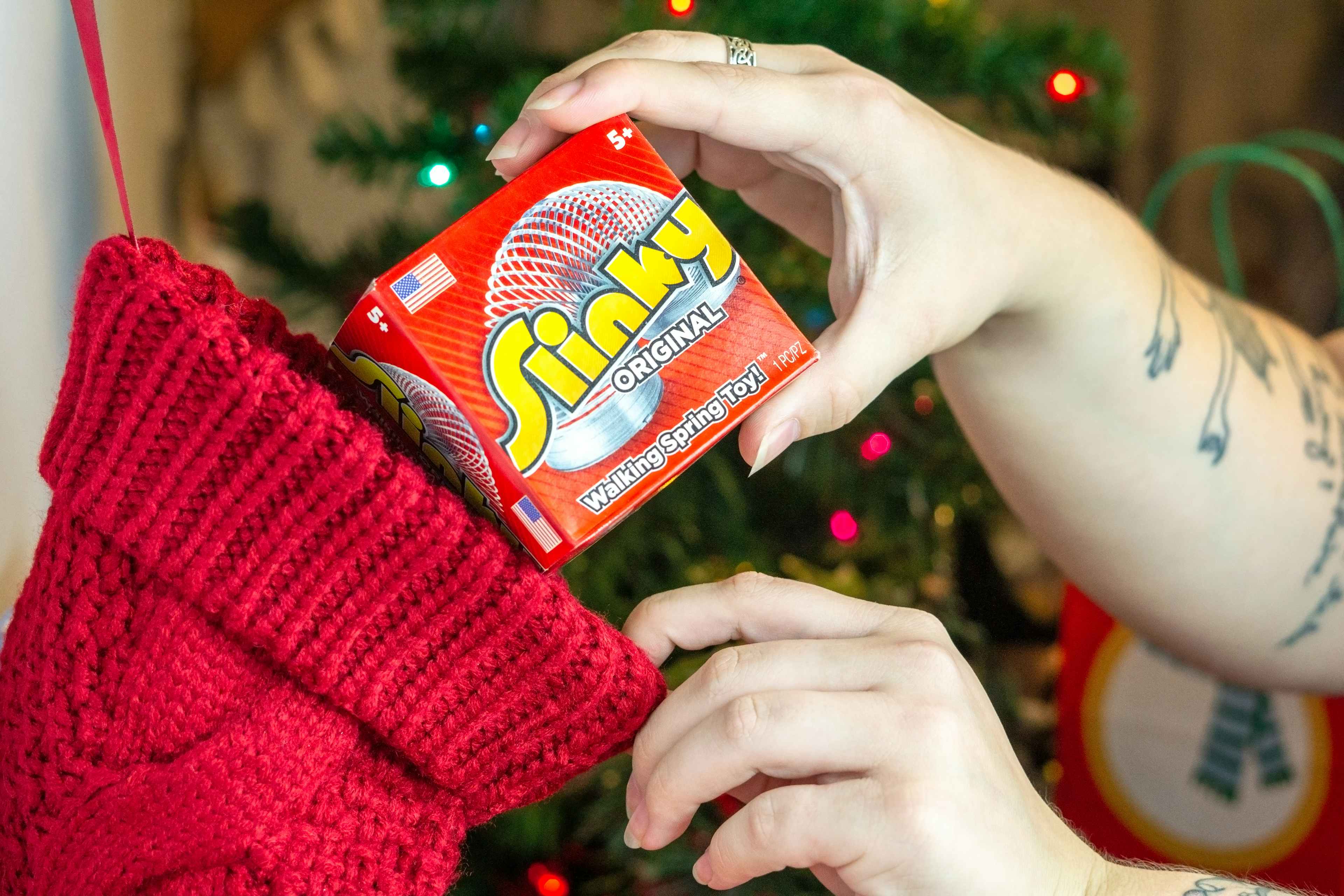 someone putting a slinky into a stocking
