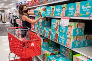 A woman shopping for Pampers diapers in Target.