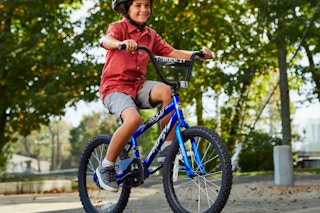lifestyle image of a child riding a bike