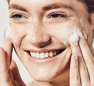 a person washing her face