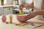 a woman using a matcha whisk set