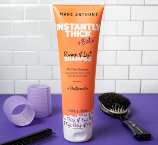 orange shampoo tube on a purple table