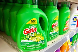 store product shelf with bottles of laundry detergent